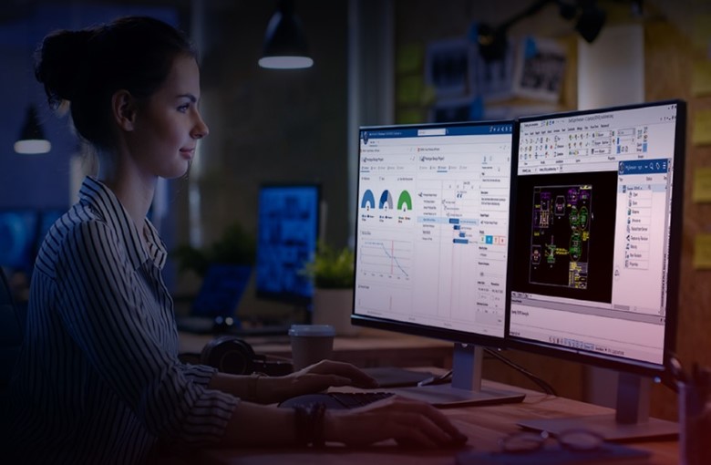 A woman sitting at a computer working on a 3DEXPERIENCE DraftSight project
