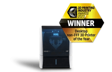 A product image of the Nexa3D XiP 3D printer with an award badge for "Desktop non-FFF 3D Printer of the Year, 2023," showcasing its compact and modern design.